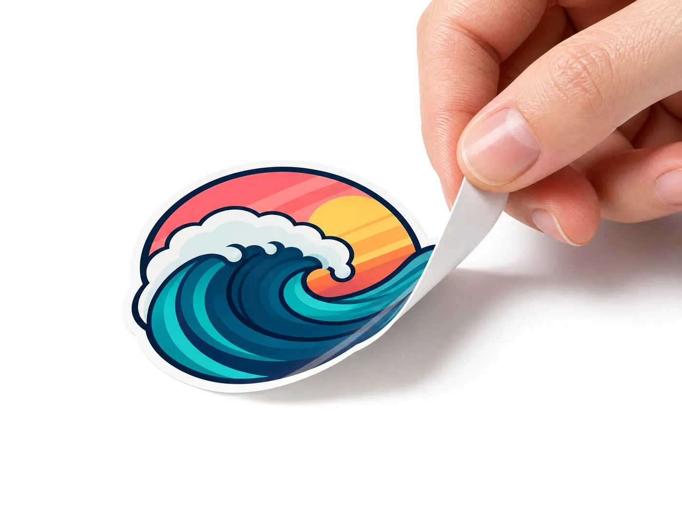 A hand peeling a glossy die-cut sample sticker off its backing paper